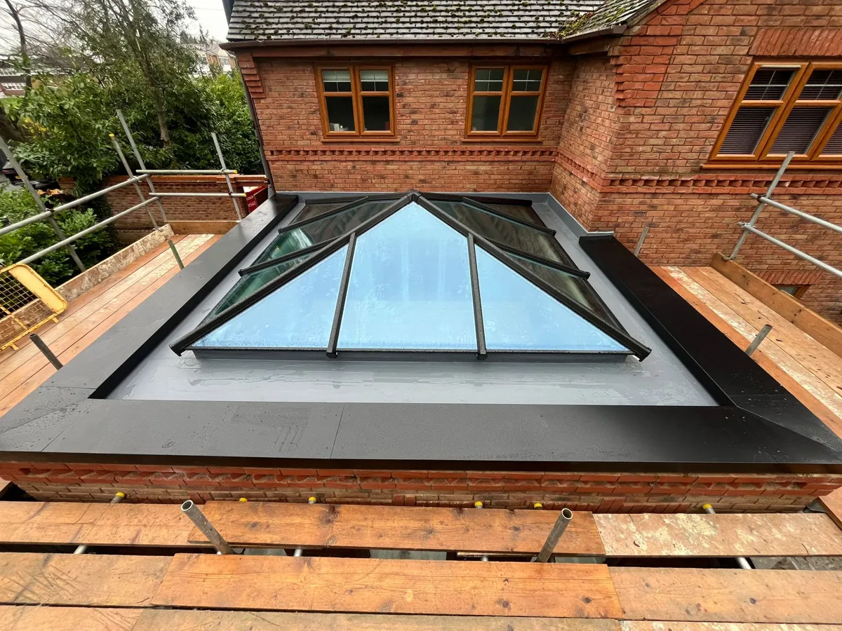 Finished anthracite aluminium roof lantern on a brick upstand, supplied by New Conservatory Roofs Ltd