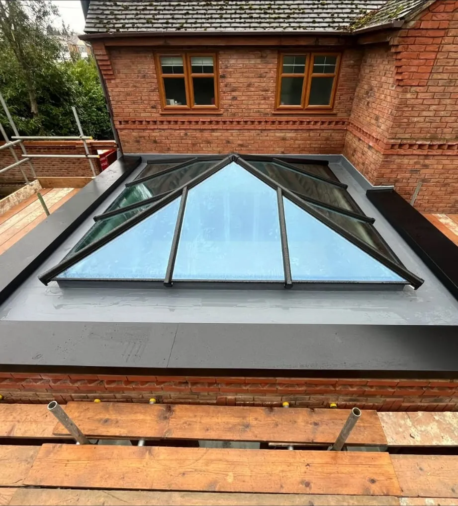 Anthracite aluminium roof lantern finished on a grey fibreglass flat roof